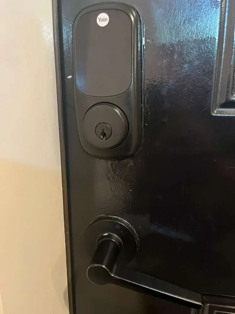 Deadbolt and lever hardware checked on a residential entry door